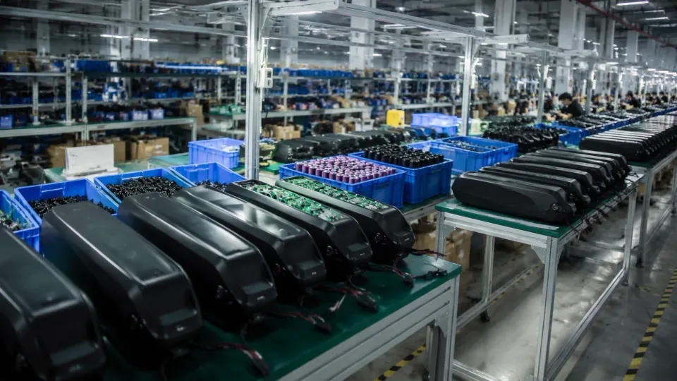 E-bike battery factory production floor with rows of finished lithium packs
